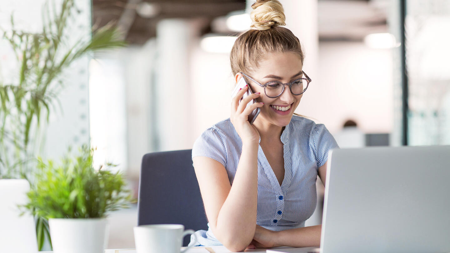 woman at a desk on a phone call