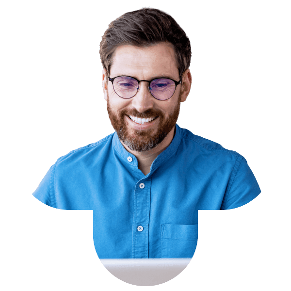 A man wearing glasses and a blue shirt smiles, symbolizing Bullhorn applicant tracking system software.