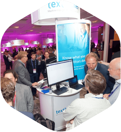 People looking at computer monitor at tradeshow