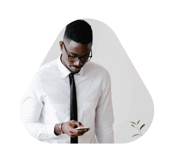 Man in tie and glasses looking down at phone